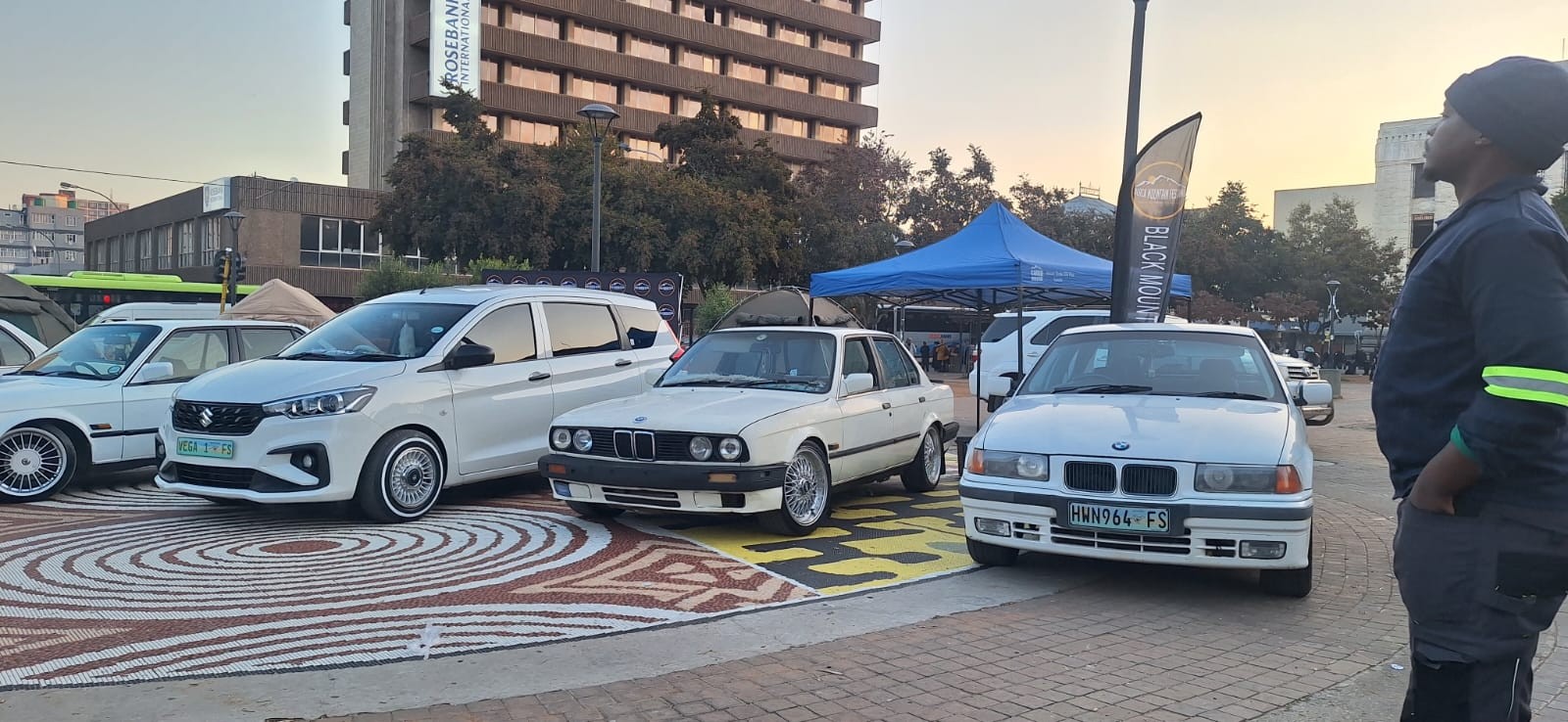 A lineup of cars at an outdoor motoring display
